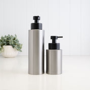 250ml and 500ml brushed 304 stainless steel refillable soap dispensers shown together for size comparison, both featuring a modern cylindrical design and satin black liquid pumps for bathroom, kitchen or shower use.