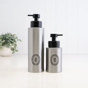 250ml and 500ml brushed 304 stainless steel refillable soap dispensers with black oval labels and satin black liquid pumps, shown together to compare bottle sizes for bathroom, kitchen or ensuite use.