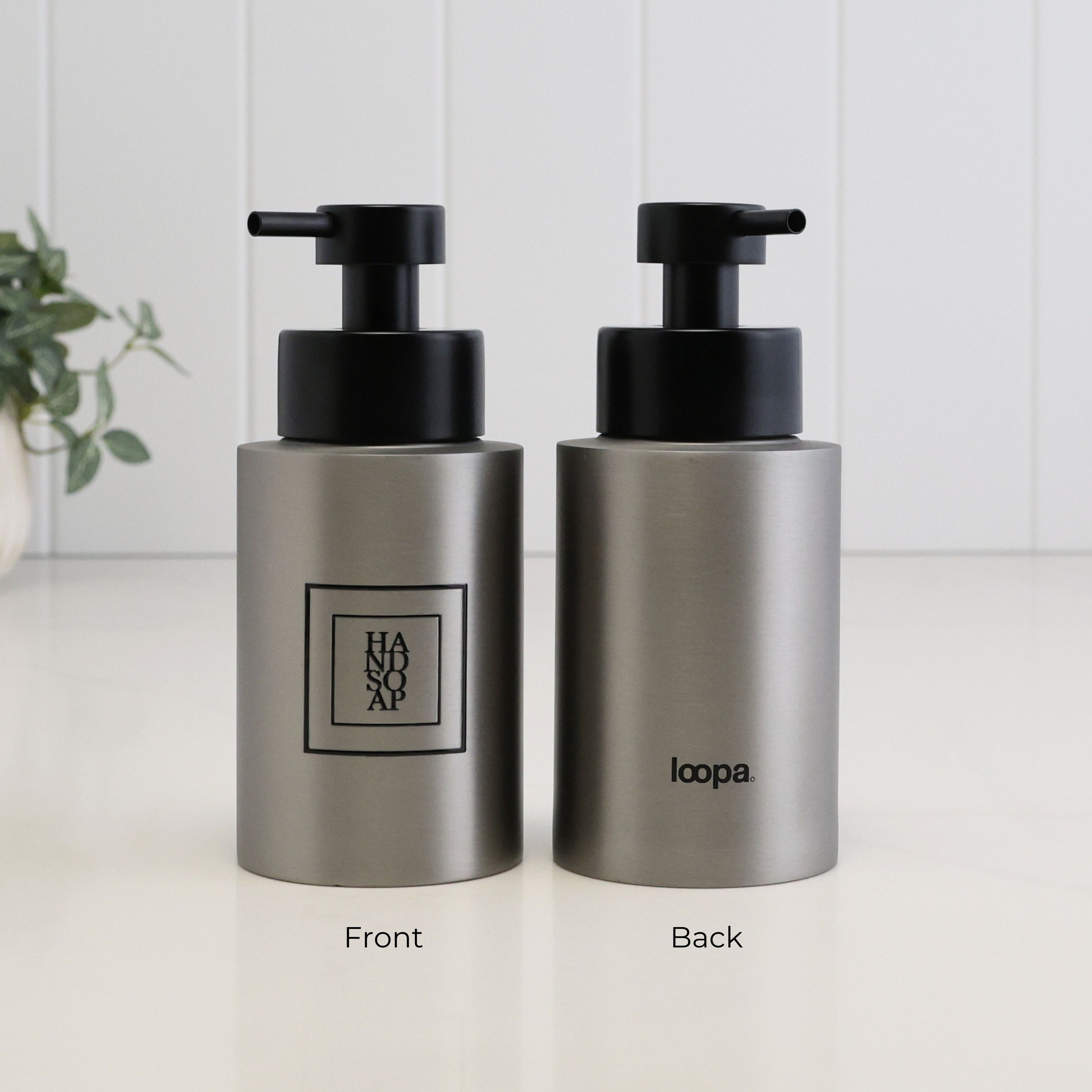 Front and back view of a 250ml brushed 304 stainless steel hand soap dispenser with black square label, Loopa branding and satin black liquid pump.