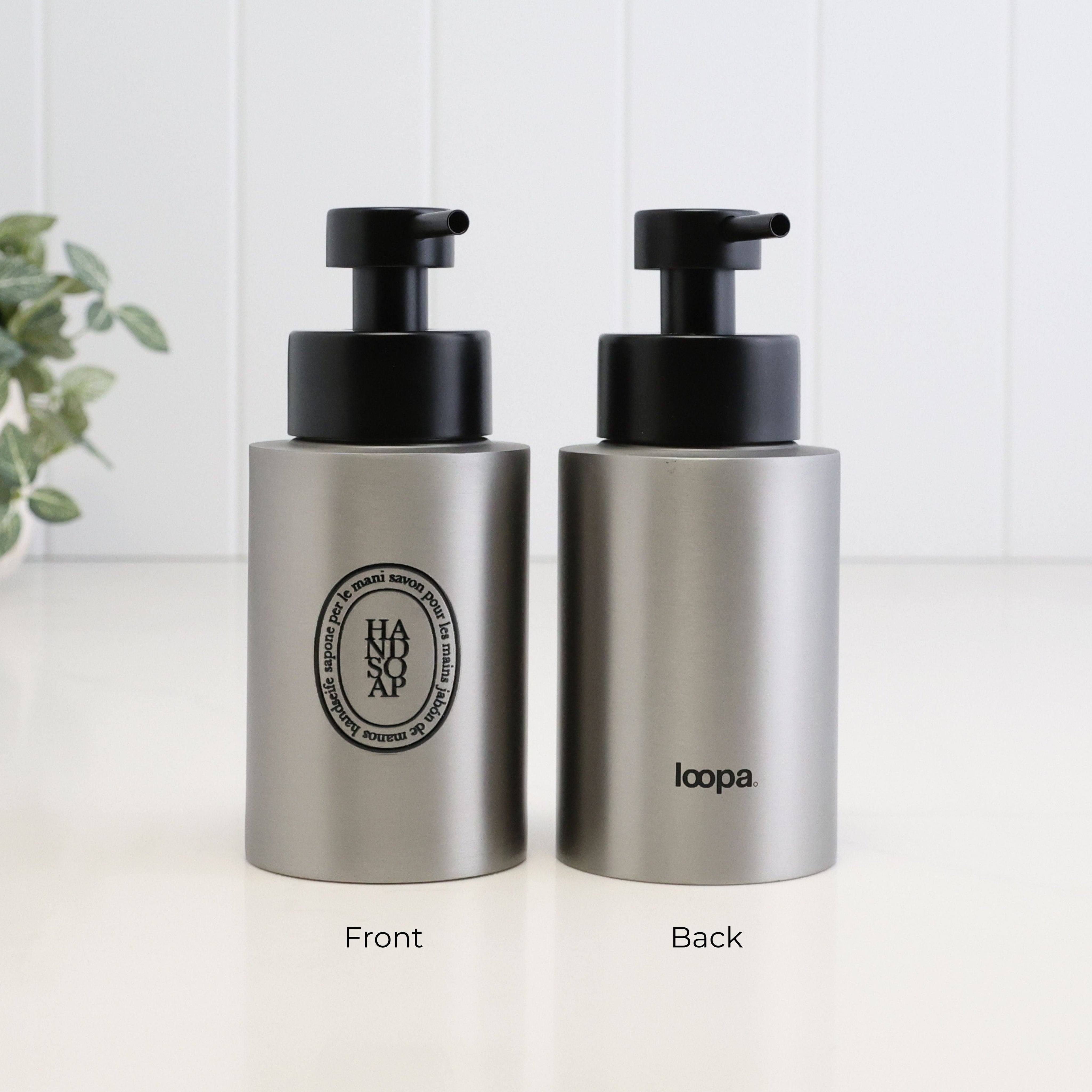Front and back view of a 250ml brushed 304 stainless steel hand soap dispenser with black oval label, satin black liquid pump and Loopa branding, showing the modern refillable bottle design for bathroom, ensuite or kitchen sinks.