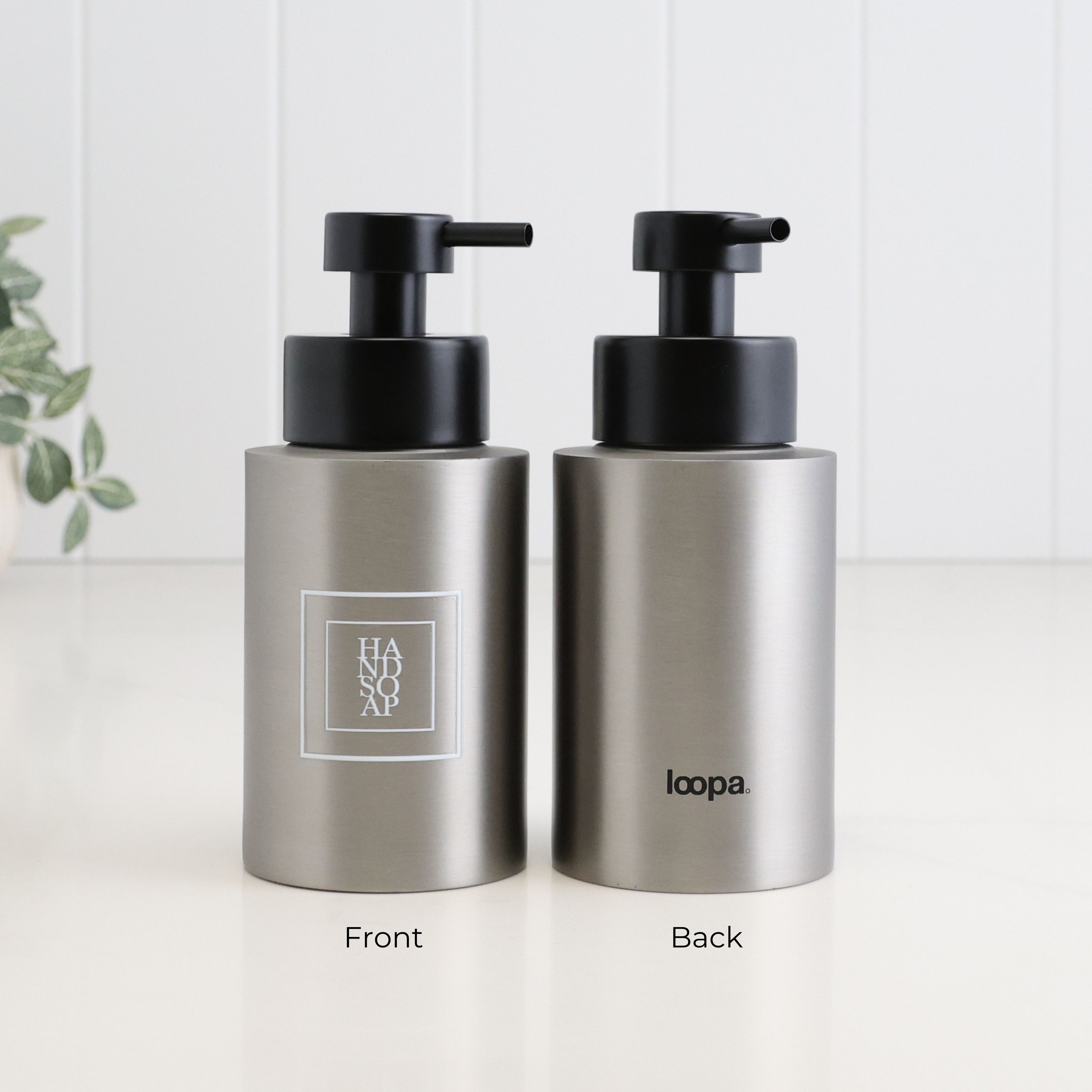 Front and back view of a 250ml brushed 304 stainless steel hand soap dispenser with white square label, Loopa branding and satin black liquid pump.