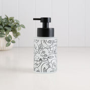 250ml frosted glass soap dispenser with black abstract face line art and satin black pump, a compact refillable hand soap or lotion bottle for bathroom sinks, ensuites and cloakrooms.