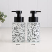 Front and back views of a 250ml frosted glass soap dispenser with black abstract face line art, satin black pump and Loopa branding, designed as a refillable hand soap or lotion dispenser for modern bathrooms and kitchens.