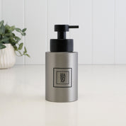 250ml refillable hand soap dispenser in brushed 304 stainless steel with a black square Hand Soap label and satin black liquid pump, designed for a modern bathroom, cloakroom or kitchen sink.