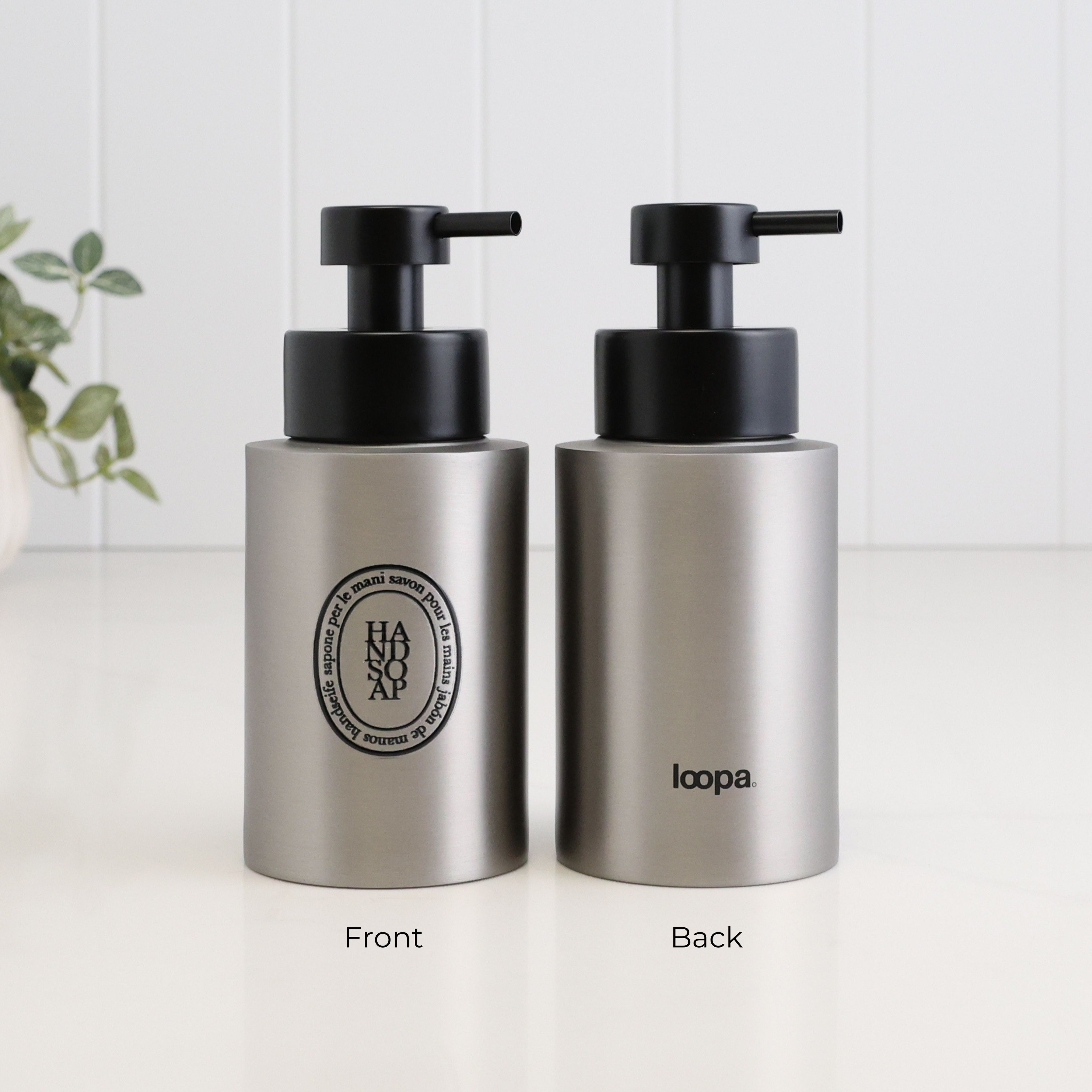 Front and back view of a 250ml brushed 304 stainless steel hand soap dispenser with black oval label, satin black liquid pump and Loopa branding, designed as a refillable soap dispenser for bathroom or kitchen sinks.