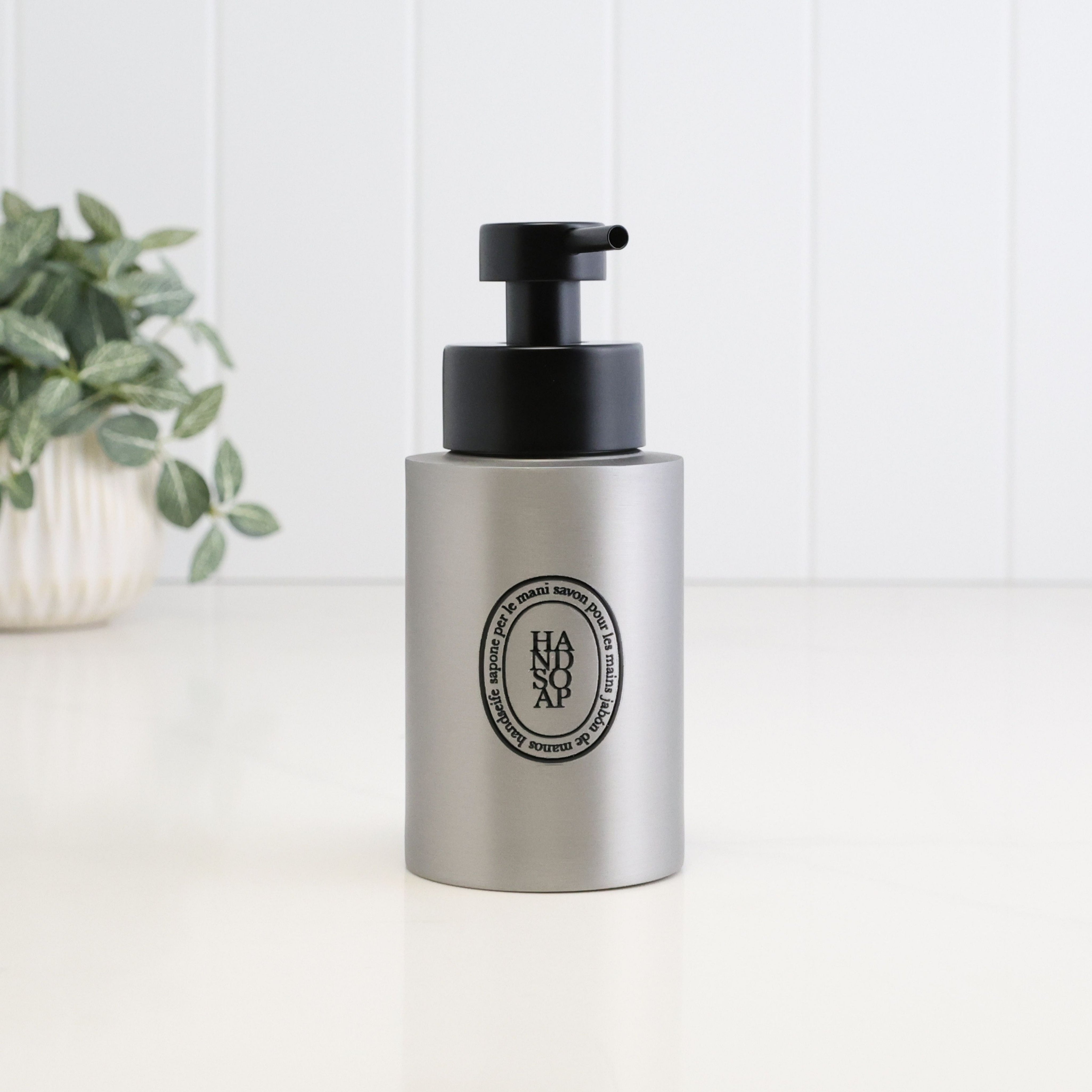 Single 250ml brushed 304 stainless steel hand soap dispenser with black oval label and satin black liquid pump, a compact refillable soap bottle for bathroom, kitchen, ensuite or cloakroom sinks.