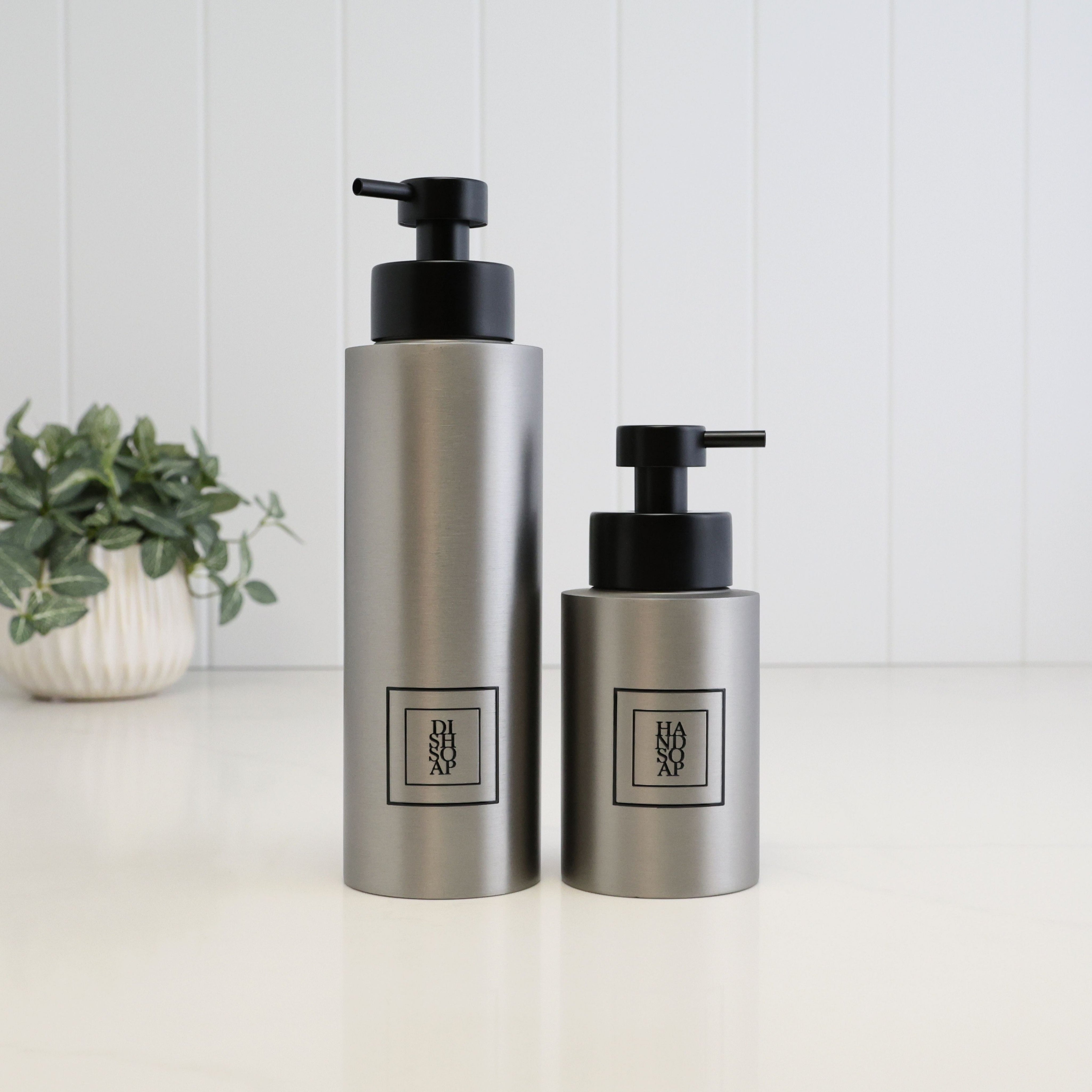 500ml dish soap and 250ml hand soap dispensers in brushed 304 stainless steel, featuring black square labels and satin black liquid pumps for a coordinated kitchen or bathroom set.