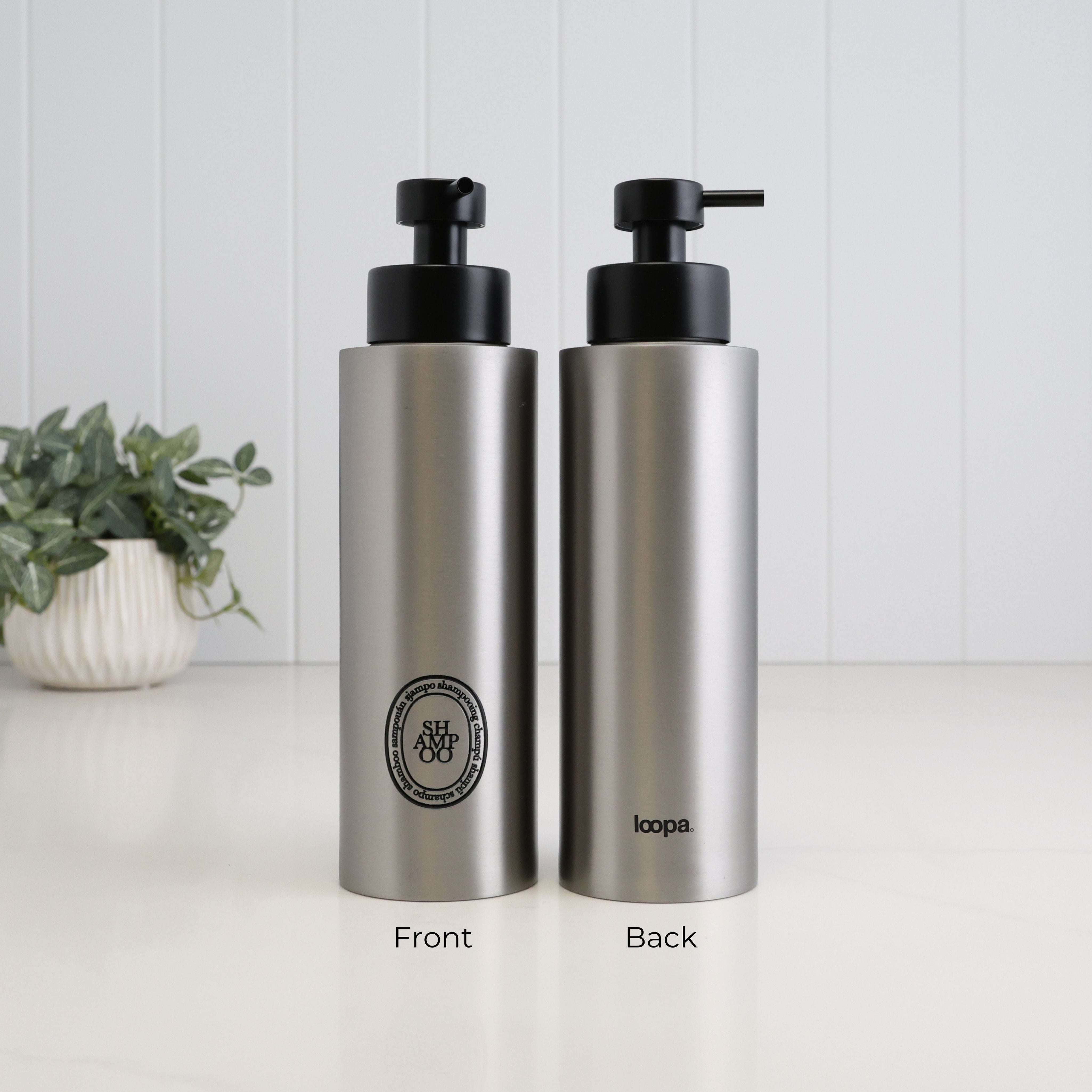 Front and back view of a 500ml brushed 304 stainless steel shampoo dispenser with black oval label, satin black liquid pump and Loopa branding, suitable for refillable shower storage.