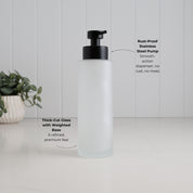 500ml frosted glass refillable soap dispenser with thick-cut weighted base and satin black stainless steel liquid pump, highlighting its premium construction and smooth-action rust-resistant dispenser.