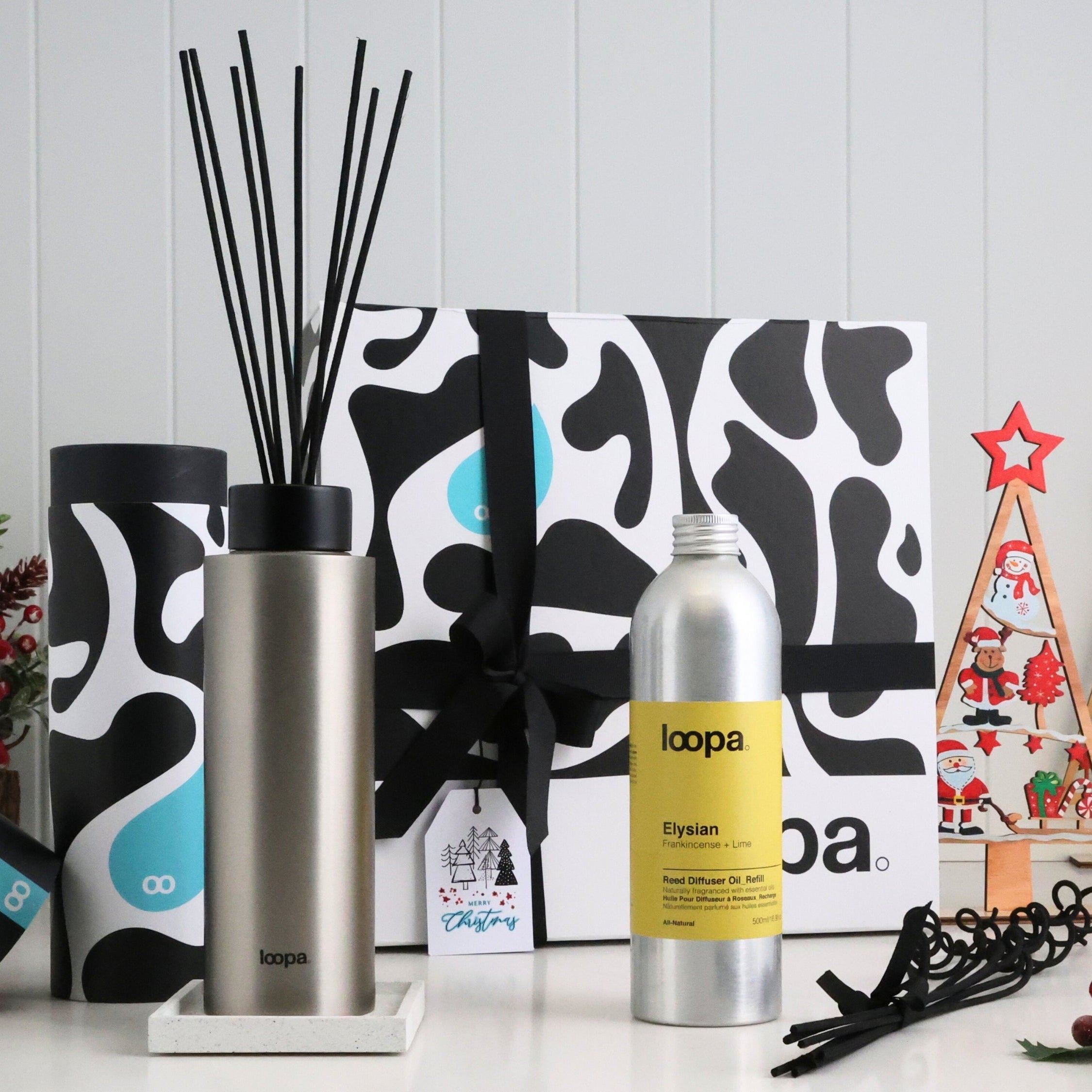 Luxury stainless steel diffuser Christmas gift set shown with festive ornaments, premium refill oil and signature Loopa packaging. A modern holiday fragrance present for stylish homes, gifting couples or winter interiors.