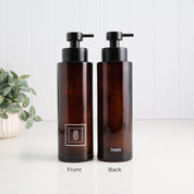 Front and back view of a tall amber glass dish soap dispenser with white square label, satin black pump and Loopa branding, designed as a refillable kitchen soap bottle.