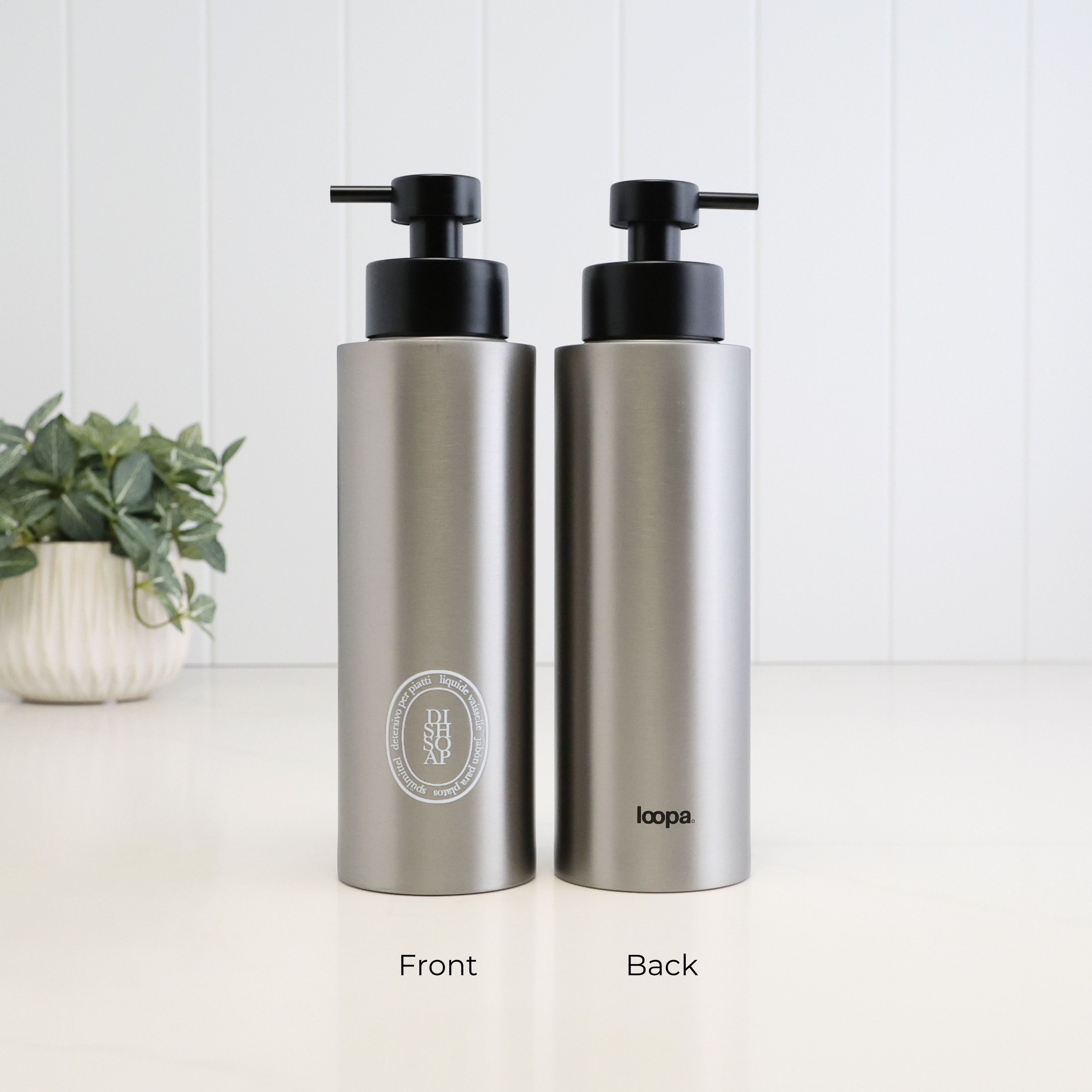 Front and back view of a 500ml brushed 304 stainless steel dish soap dispenser with white oval label, satin black liquid pump and Loopa branding on the reverse.