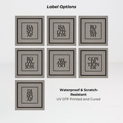 Brushed stainless steel round bottle dispenser displaying black square label options for organising refillable bottles across kitchens, bathrooms, cloakrooms, or WC spaces