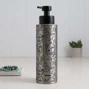Brushed stainless steel round bottle dispenser with a black wrap label, shown as a 500ml refillable bottle suited to contemporary kitchen or bathroom spaces