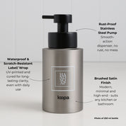 Brushed stainless steel round bottle dispenser with a white square label and arrow detailing, shown as a 250ml refillable bottle for kitchens, bathrooms, or shower spaces
