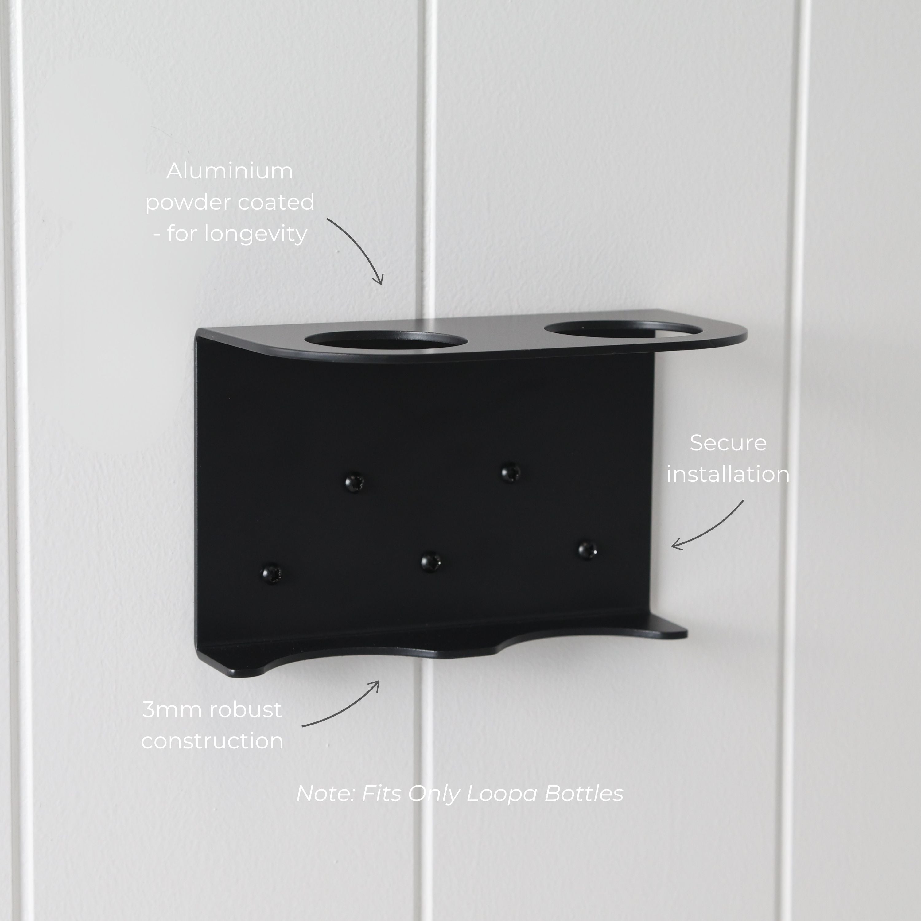 Loopa double wall-mounted soap dispenser holder made from durable 3mm aluminium with a protective black powder-coated finish. Featuring two circular bottle openings, a sturdy supporting base and secure wall fixings, this bracket provides an organised storage solution for bathrooms and showers. Designed exclusively for Loopa refillable 250ml and 500ml dispenser bottles.