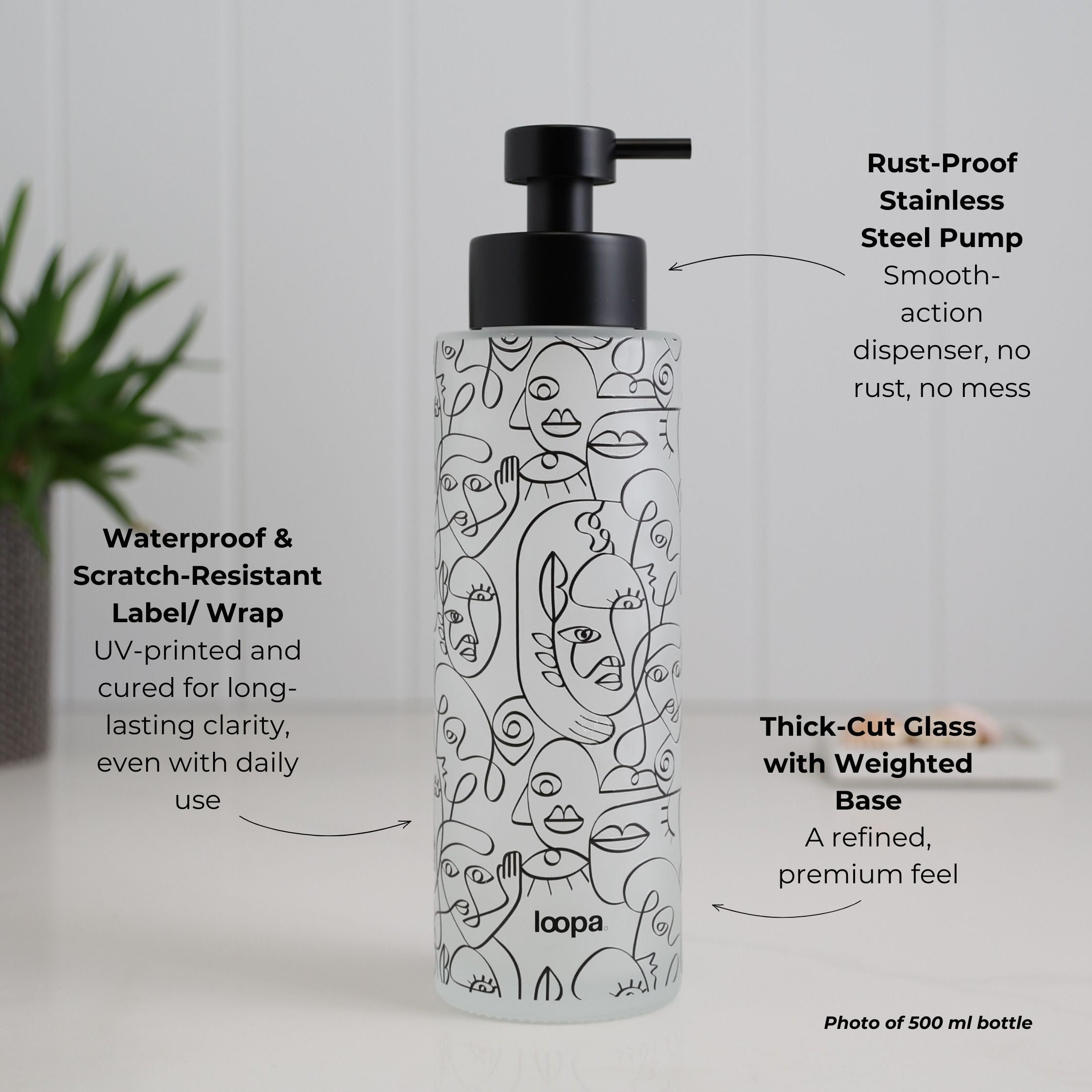 Frosted glass bottle dispenser featuring a black wrap with arrow detailing, designed for refillable soap or lotion use in refined home spaces