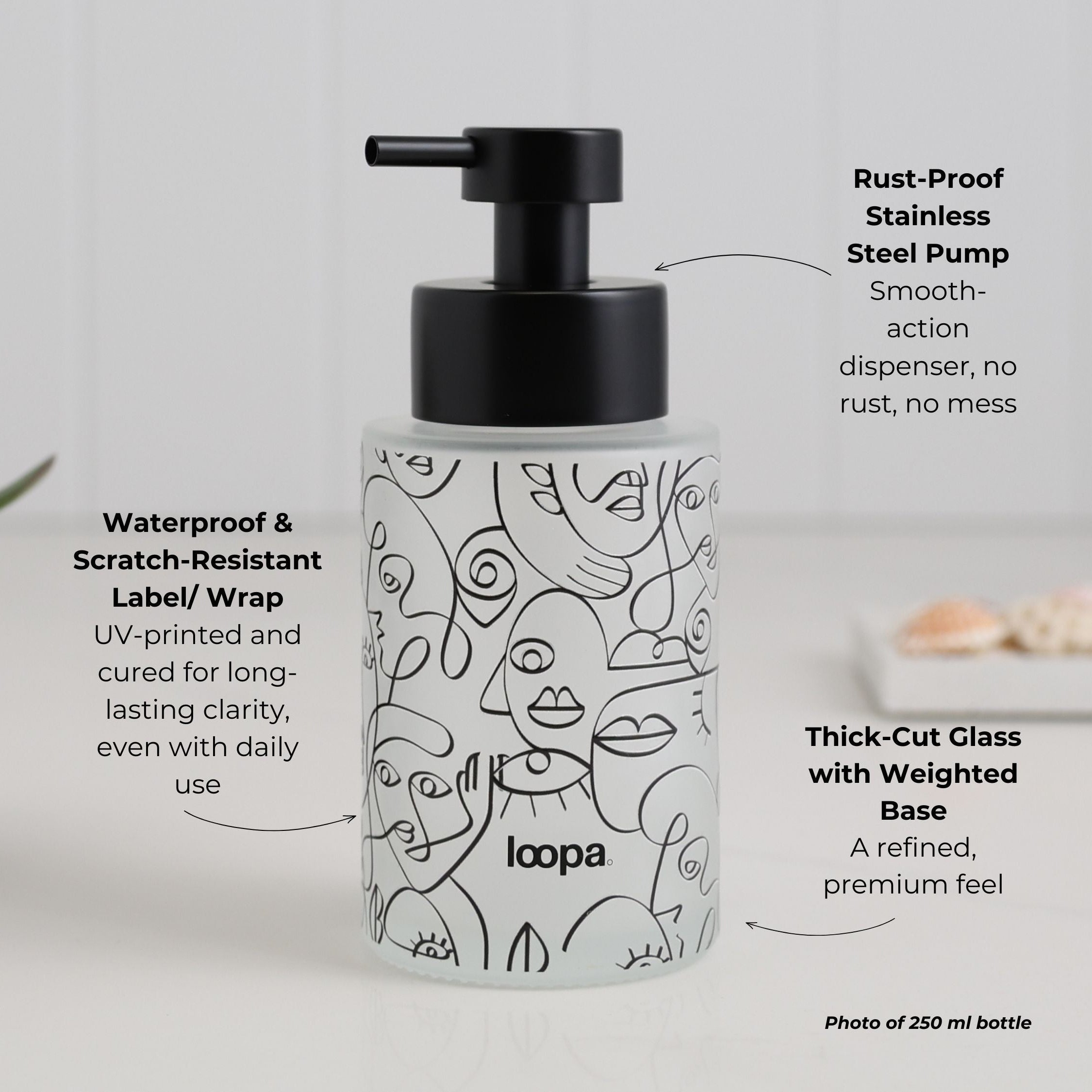 Frosted glass bottle dispenser with a black wrap and subtle arrow motif, intended for refillable soap or lotion in modern interiors