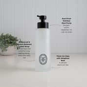 500ml frosted glass conditioner dispenser with black oval label and satin black stainless steel pump, highlighting thick-cut weighted glass and a waterproof, scratch-resistant UV-DTF label.