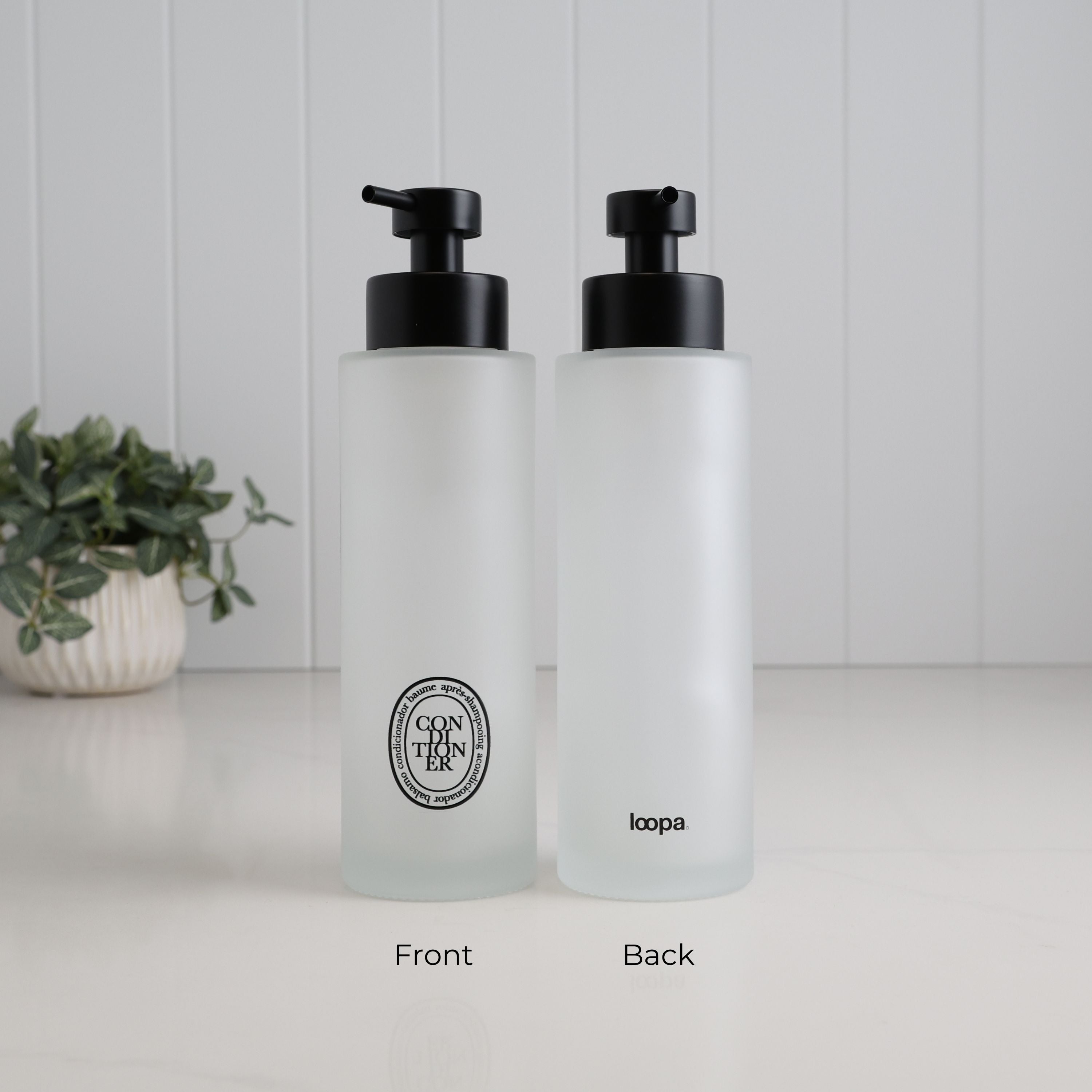 500ml frosted glass conditioner dispenser shown from the front and back, with a black oval Conditioner label, satin black pump and Loopa branding.