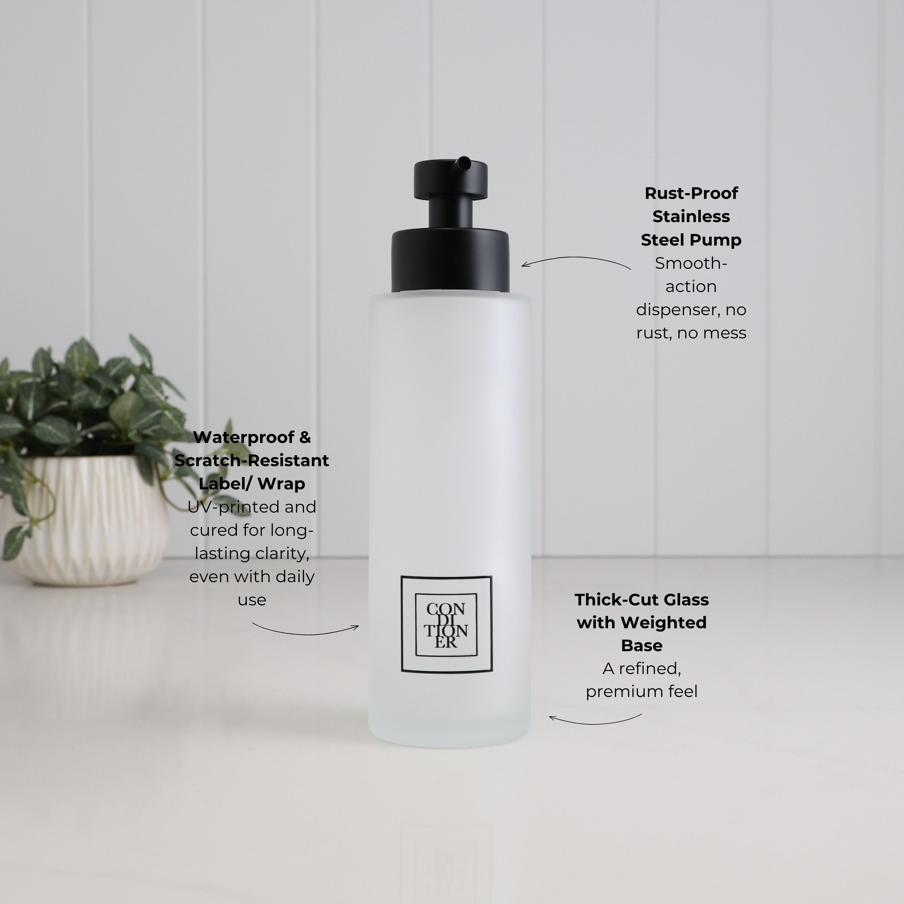 500ml frosted glass conditioner dispenser with black square label, satin black stainless steel pump and thick-cut weighted base, highlighting the waterproof scratch-resistant UV DTF label.