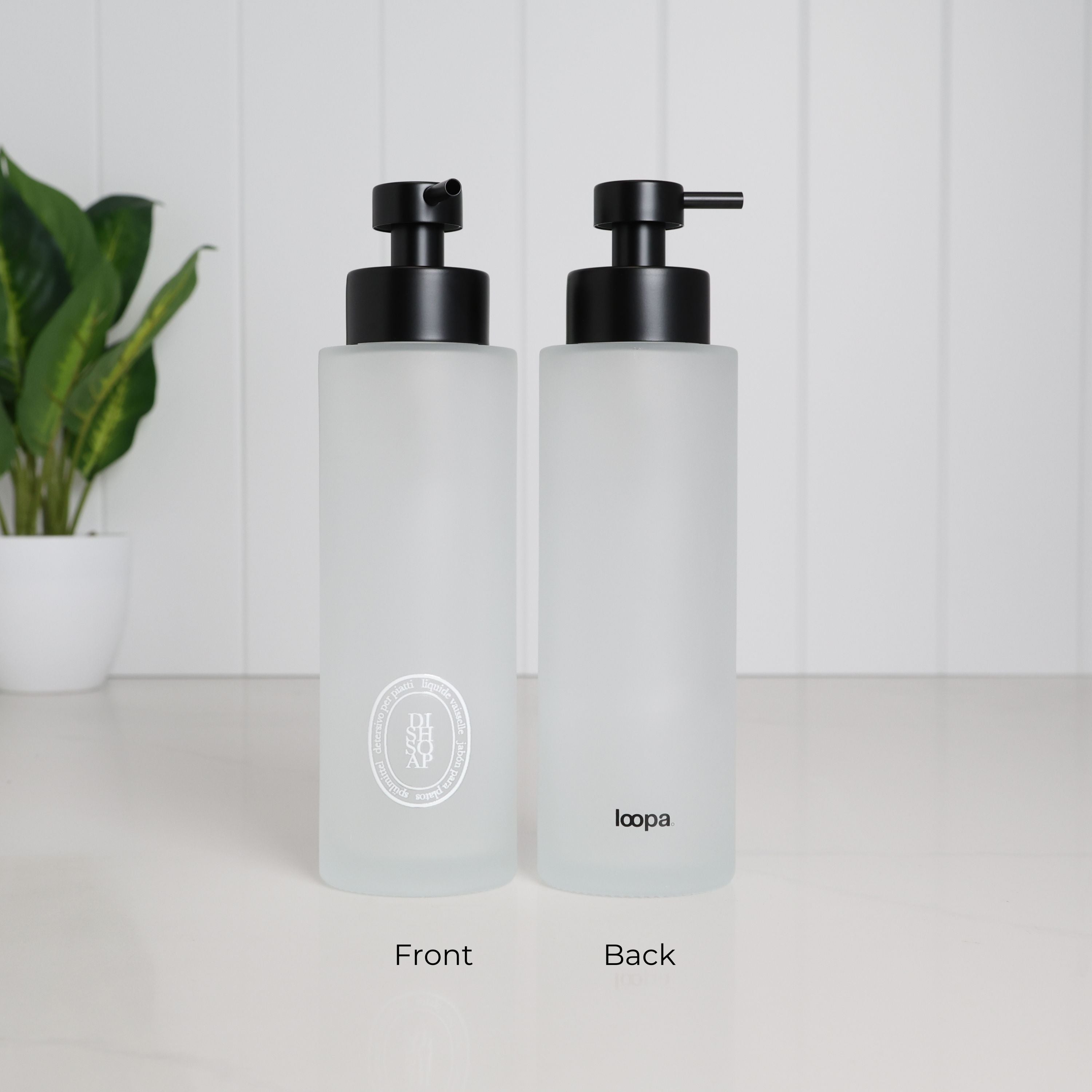 Front and back view of a 500ml frosted glass dish soap dispenser with white oval label, Loopa branding and satin black stainless steel pump.