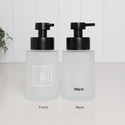 250ml frosted glass hand soap dispenser with white square Hand Soap label and satin black stainless steel pump, shown held in hand to demonstrate the compact size of the refillable bathroom sink bottle.