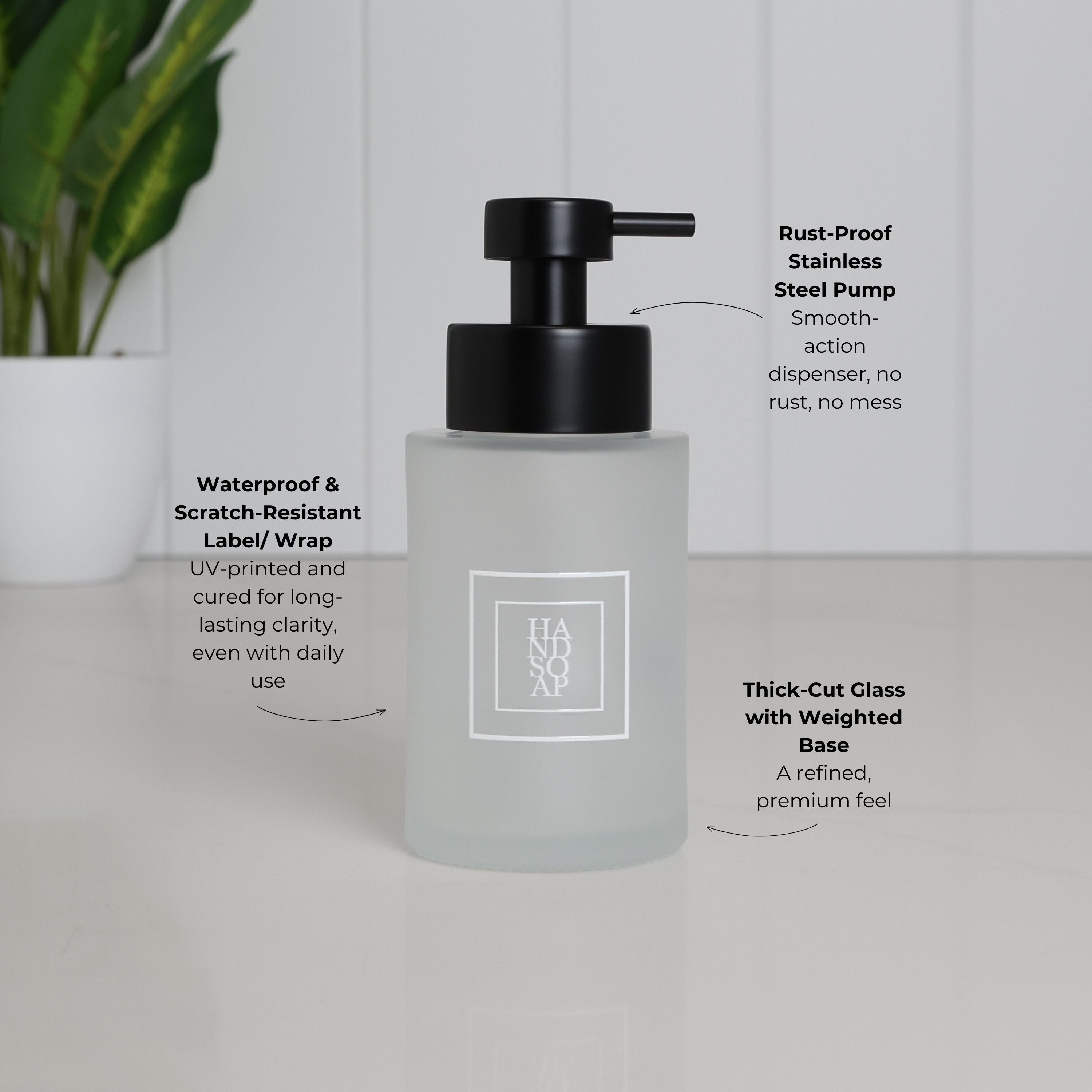 250ml frosted glass hand soap dispenser with white square label and satin black stainless steel pump, highlighting the waterproof scratch-resistant UV-DTF label, thick-cut weighted glass base and smooth-action pump.