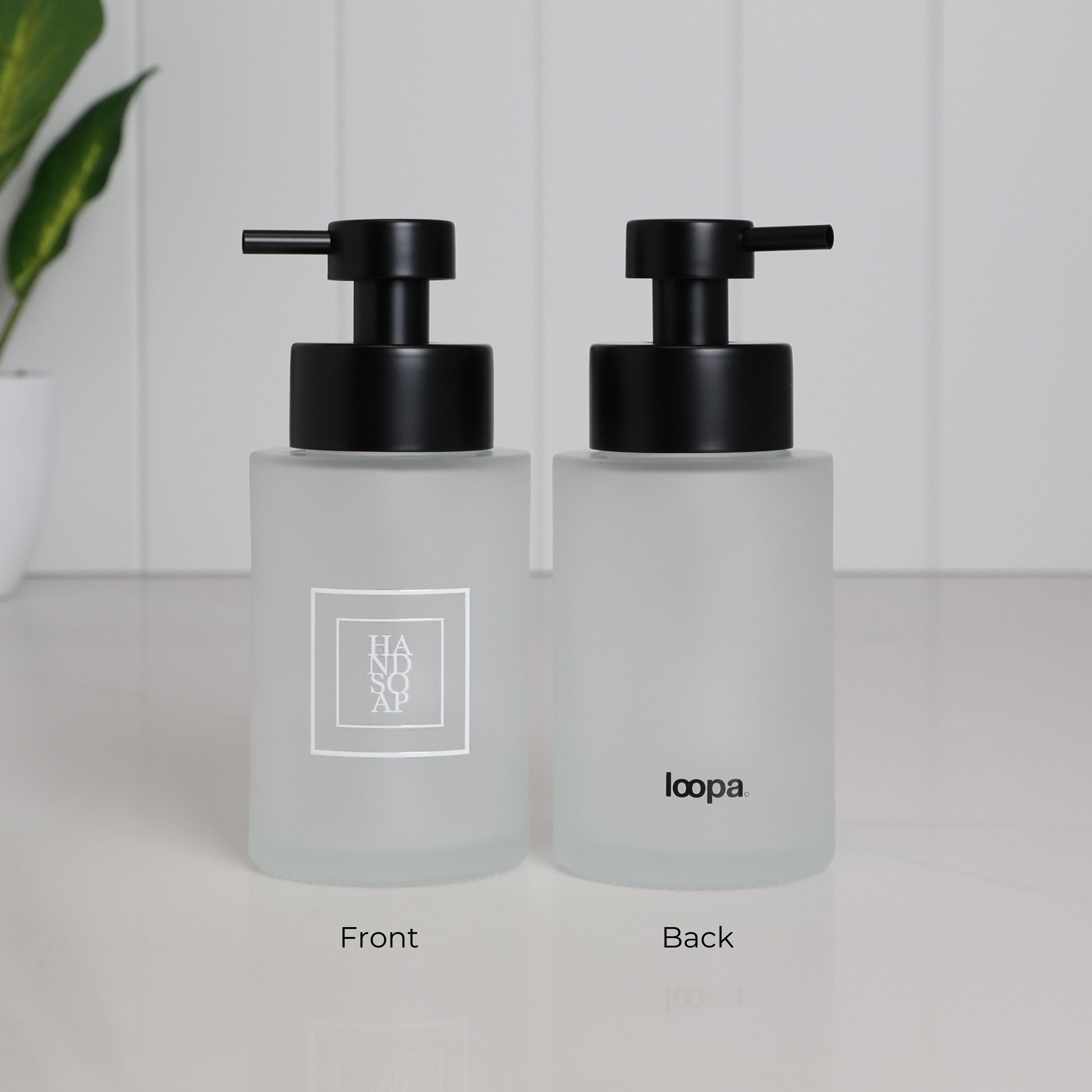 250ml frosted glass hand soap dispenser shown from the front and back, with white square Hand Soap label, Loopa branding and satin black stainless steel pump, designed as a refillable soap bottle for bathroom sinks.
