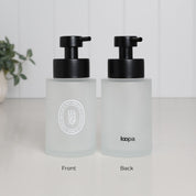 Front and back view of a 250ml frosted glass hand soap dispenser with white oval label, Loopa branding and satin black stainless steel liquid pump.