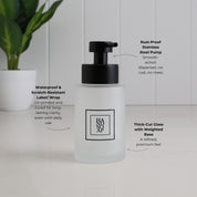 250ml frosted glass hand soap dispenser with black square label, thick-cut weighted base and satin black stainless steel pump, highlighting the waterproof scratch-resistant UV-printed label.