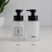 Front and back view of a 250ml frosted glass hand soap dispenser with black square label, Loopa branding and satin black stainless steel liquid pump.