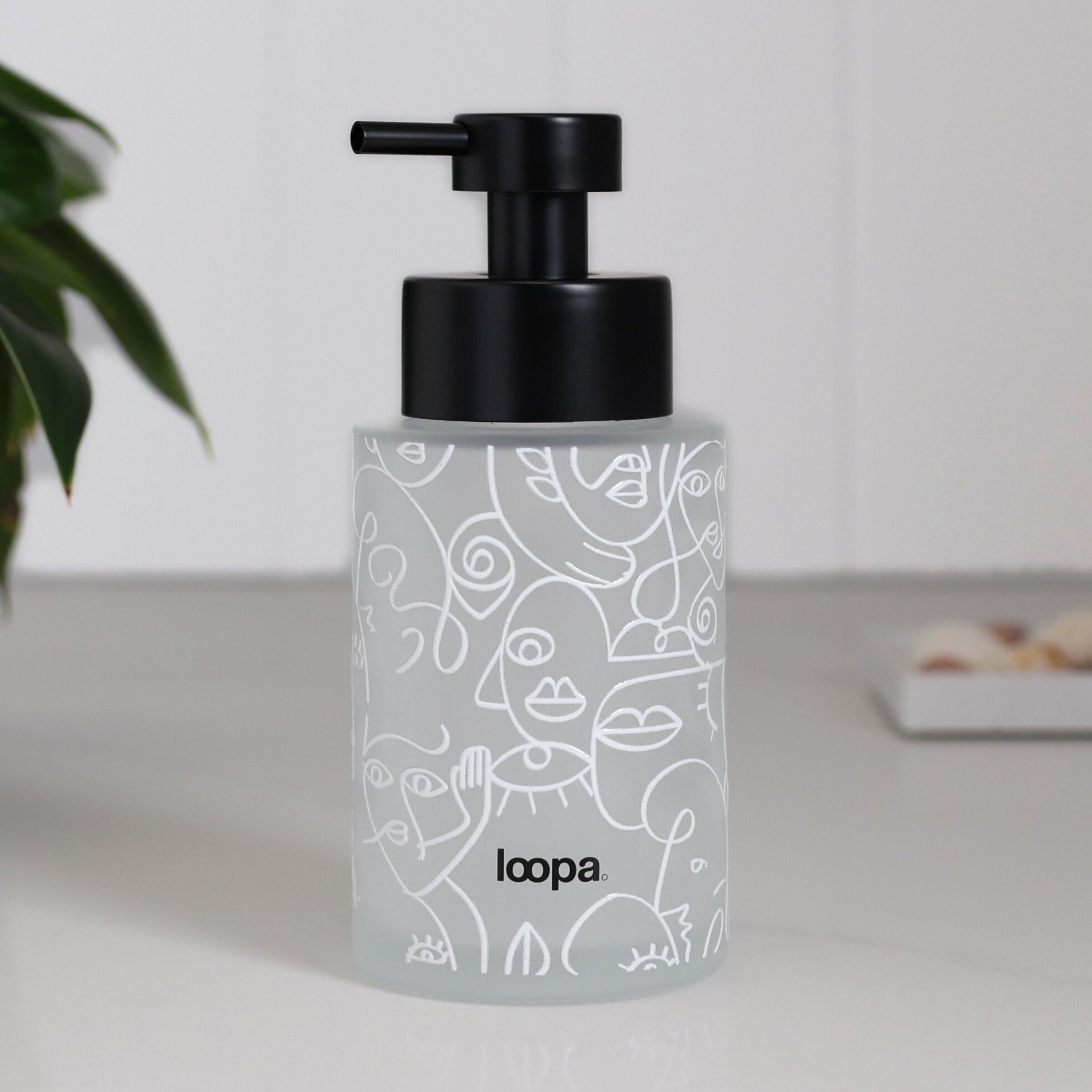 Refillable frosted glass bottle dispenser with a clean white wrap, suited to everyday soap or lotion use in kitchens and bathrooms