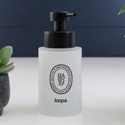 Single frosted glass round bottle dispenser with a black oval label, shown as a 250ml refillable option for everyday soap or lotion use