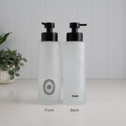 Front and back view of a 500ml frosted glass shampoo dispenser with black oval label, satin black pump and Loopa branding, designed as a refillable bathroom and shower soap dispenser.