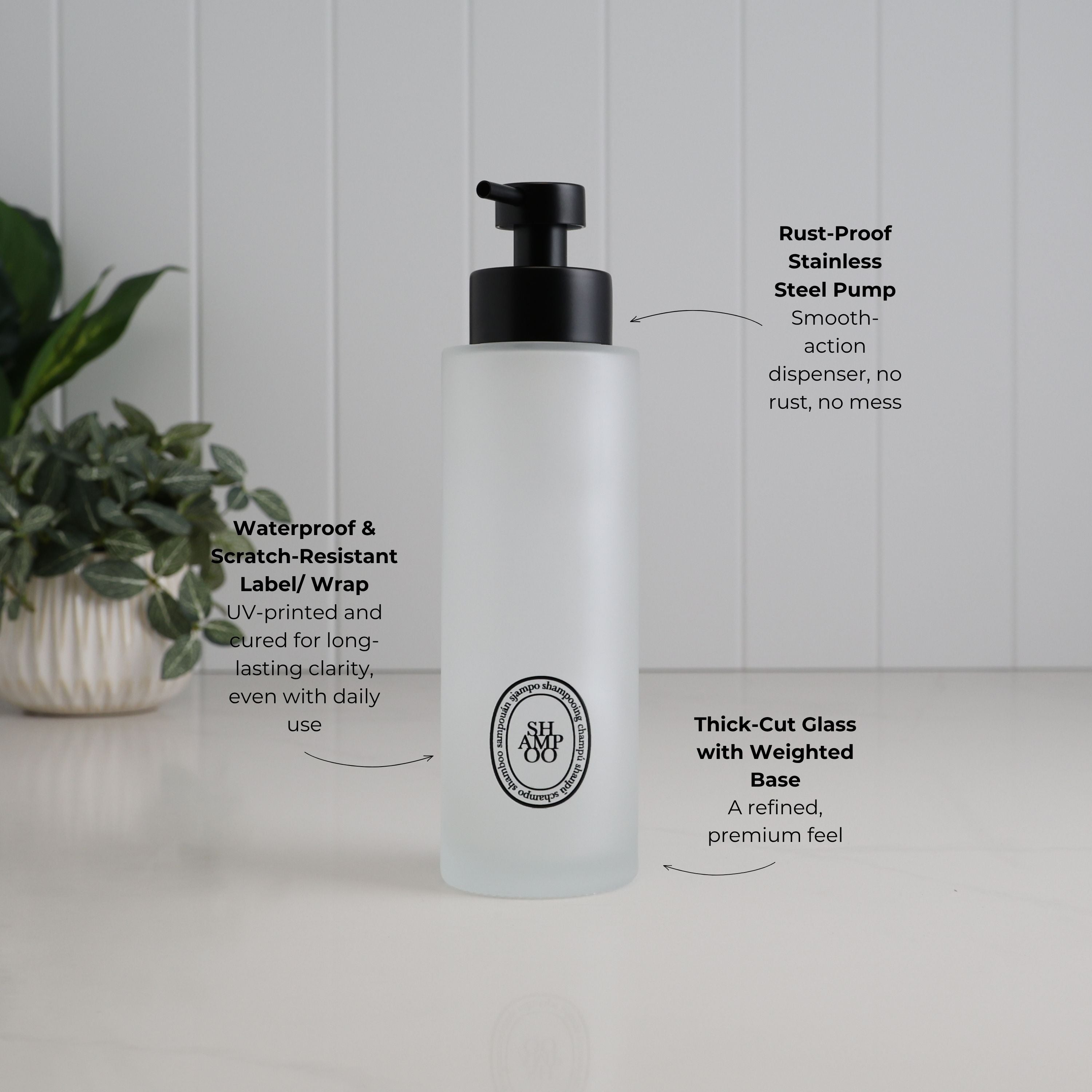 500ml frosted glass shampoo dispenser with black oval label and satin black stainless steel pump, highlighting the thick-cut weighted glass and waterproof, scratch-resistant UV-DTF label.