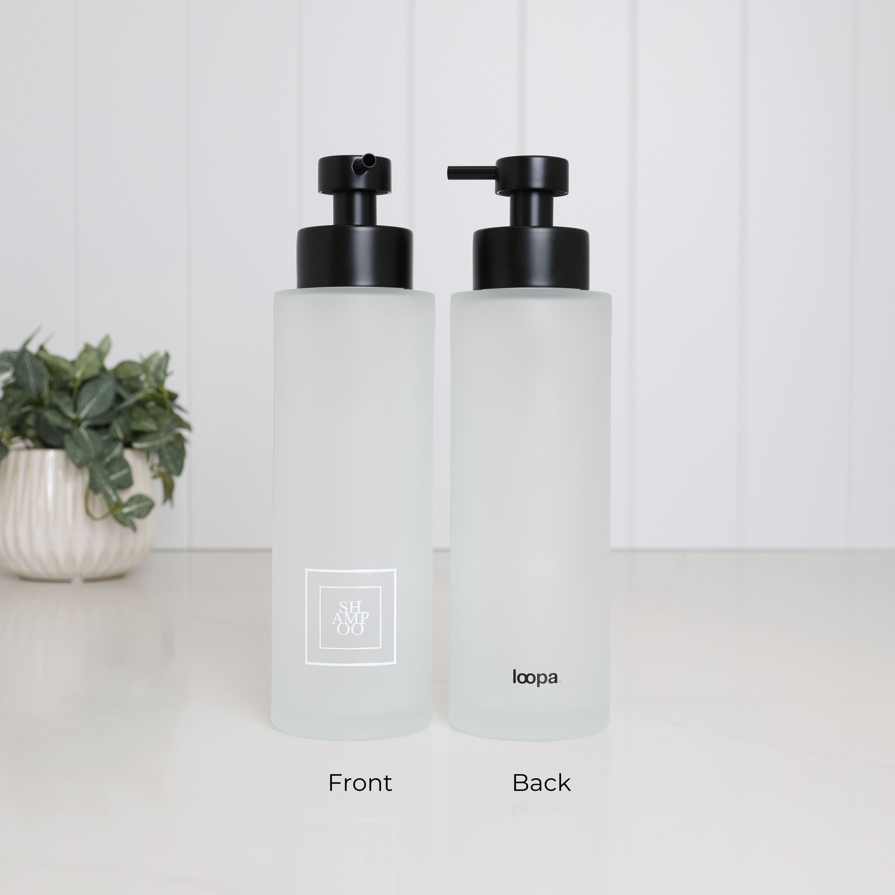 500ml frosted glass shampoo dispenser shown from the front and back, with white square Shampoo label, Loopa branding and satin black pump, designed as a refillable bathroom bottle for shampoo.