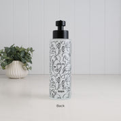 Back view of a tall frosted glass soap dispenser with black abstract face line art, Loopa branding and satin black pump, showing the decorative finish of the refillable 500ml bathroom bottle.