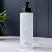 Frosted glass soap dispenser bottle with a white wrap label, designed as a refillable piece for modern kitchen or bathroom spaces