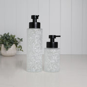 Frosted glass soap dispenser set with abstract face line art design, 500ml and 250ml refillable pump bottles with matte black stainless steel pumps, modern bathroom decor accessories for hand soap lotion or shampoo, artistic reusable glass dispensers for stylish sink or vanity setup, minimalist luxury homeware set with decorative printed finish