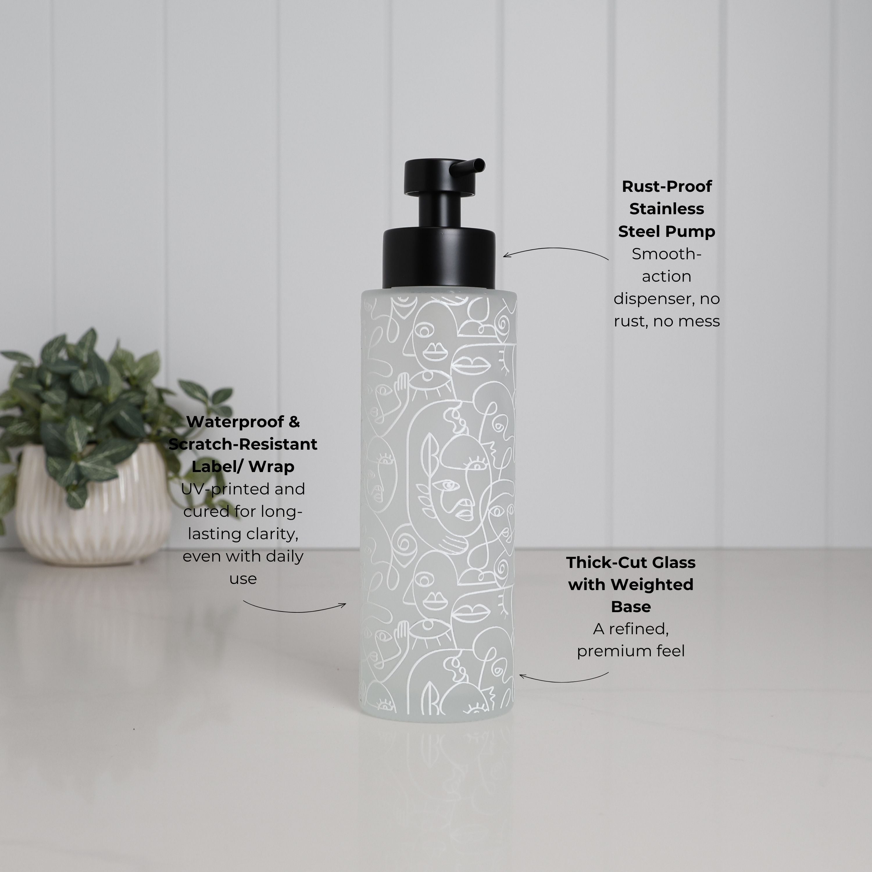 Frosted glass soap dispenser with abstract face line art wrap, 500ml refillable pump bottle with matte black stainless steel pump, waterproof scratch resistant UV printed design for long lasting use, thick weighted glass base for stability on bathroom surfaces, modern decorative hand soap or lotion dispenser for stylish sink or vanity setup