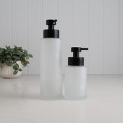 250ml and 500ml frosted glass refillable soap dispensers shown together for size comparison, both fitted with satin black liquid pumps for a modern bathroom or kitchen.