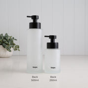 Back view of 500ml and 250ml frosted glass refillable soap dispensers with Loopa branding and matching satin black liquid pumps, clearly showing both bottle sizes side by side.