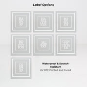 Square frosted glass dispenser bottle showing multiple white label options for refillable soap or lotion use