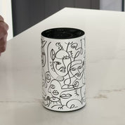 Video showcasing the Loopa white waterless essential oil diffuser with black abstract face illustrations and a minimalist cylindrical metal body. The close-up highlights the decorative line art design and top control panel for adjusting fragrance intensity and timer settings. This cordless, rechargeable aromatherapy diffuser uses pure essential oils without water or heat, offering portable home fragrance for bedrooms, bathrooms and living spaces.