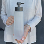Video showing a 500ml frosted glass refillable soap dispenser held in hand to demonstrate its size, finish and satin black liquid pump.