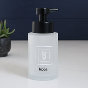 Matte square frosted glass bottle dispenser with a simple white label, designed for refillable everyday soap or lotion use